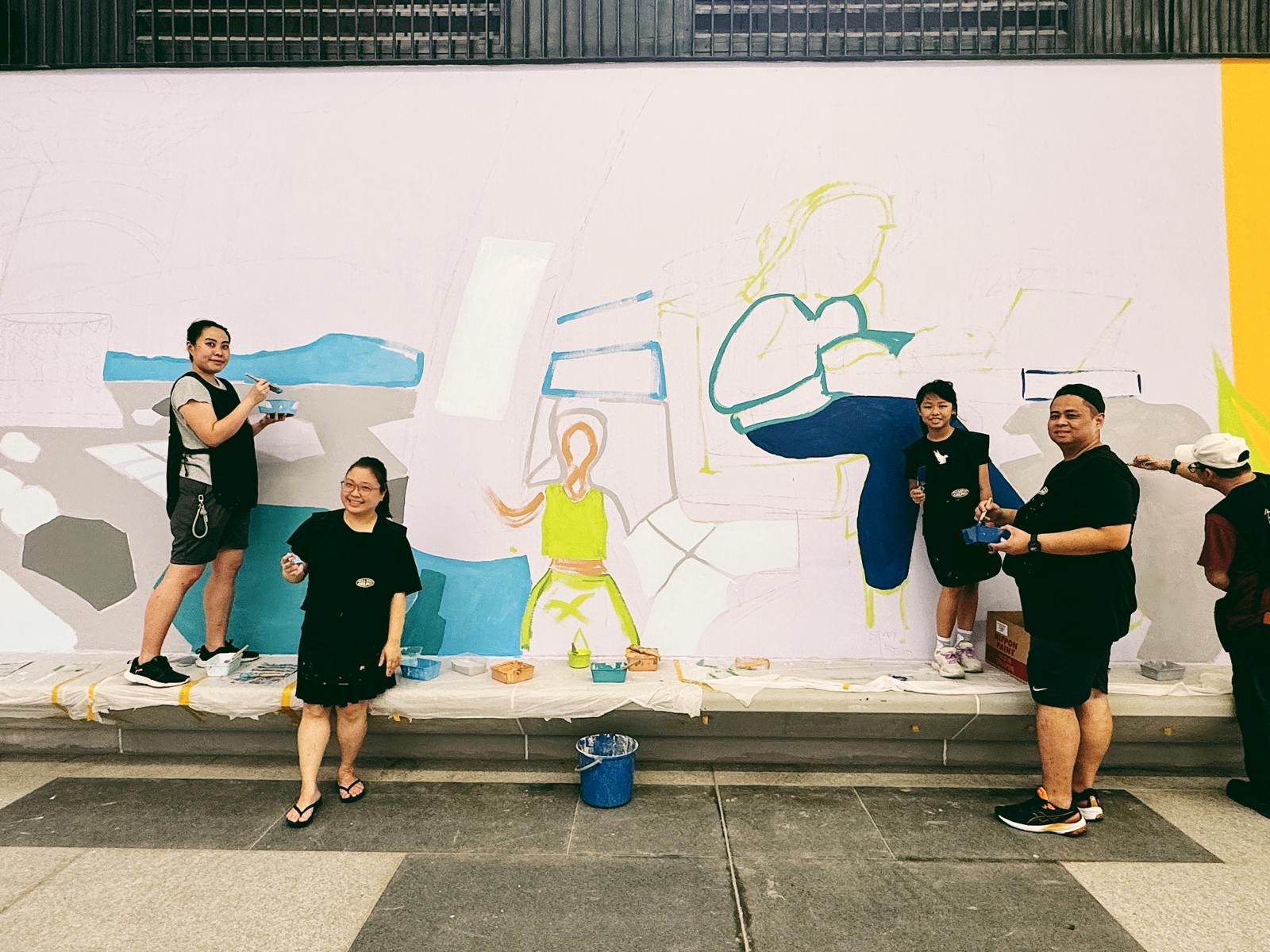 Behind the scenes photo of artists reviewing progress onsite