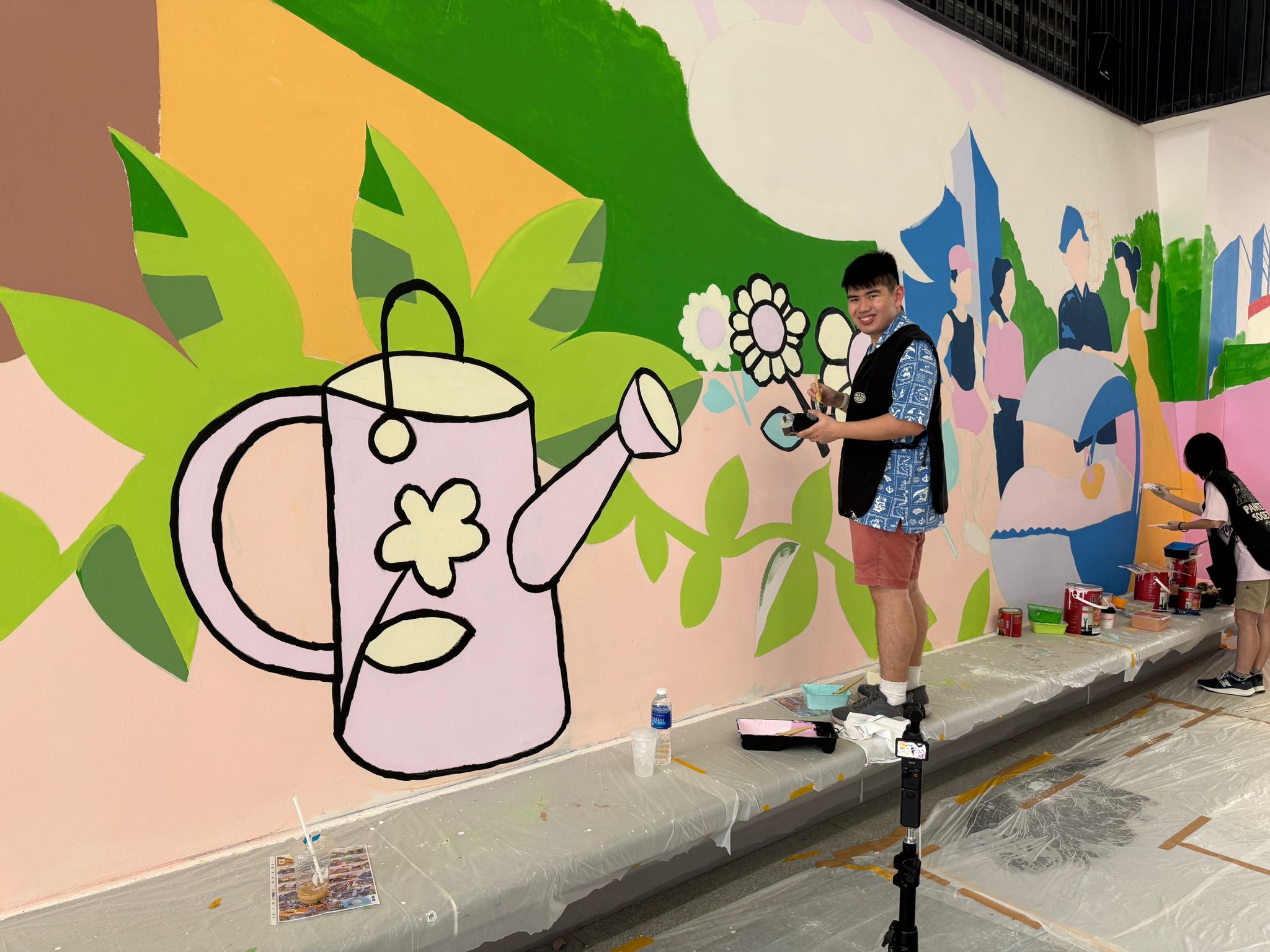 Behind the scenes photo capturing mural painting in progress